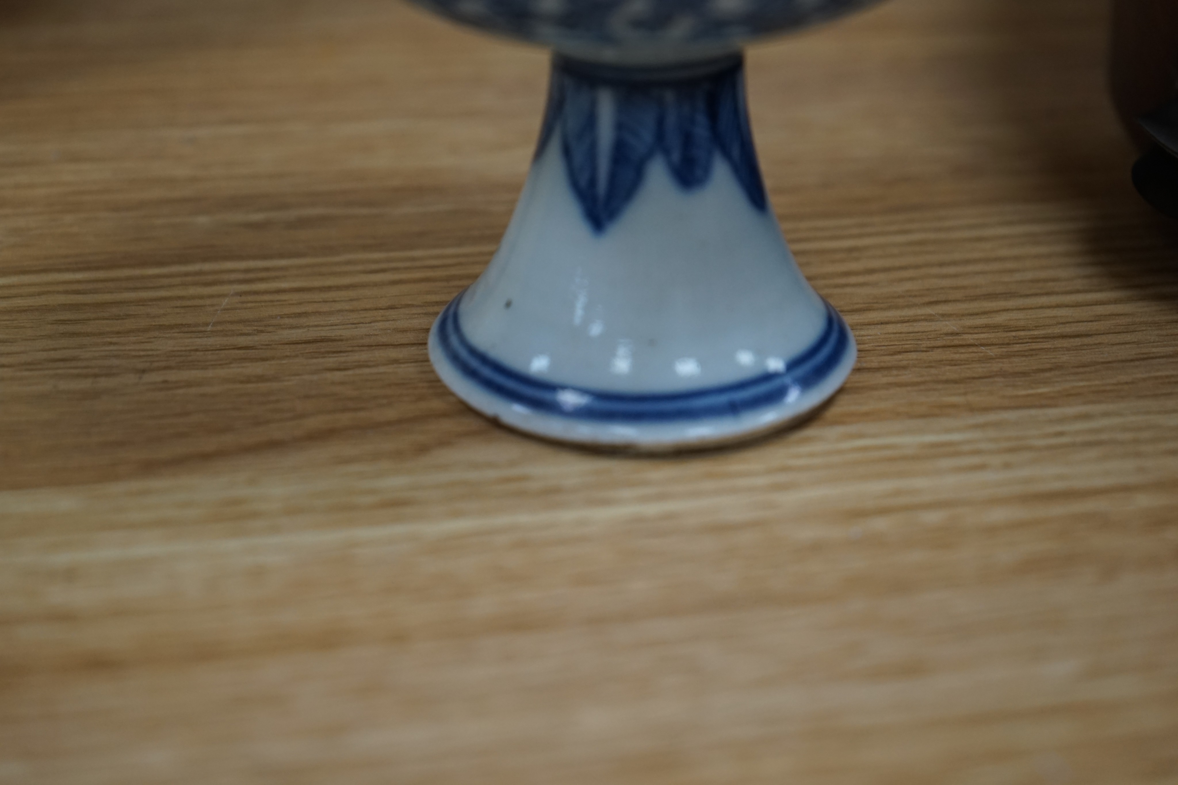 A Chinese blue and white ovoid jar and cover and similar stacking box, Kangxi and a Qing blue and white footed cup, tallest 15cm